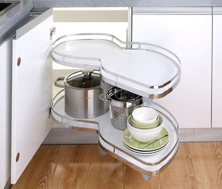Modern accessible kitchen featuring a pull-out corner cabinet organizer for easy-to-reach cookware and improved kitchen accessibility.
